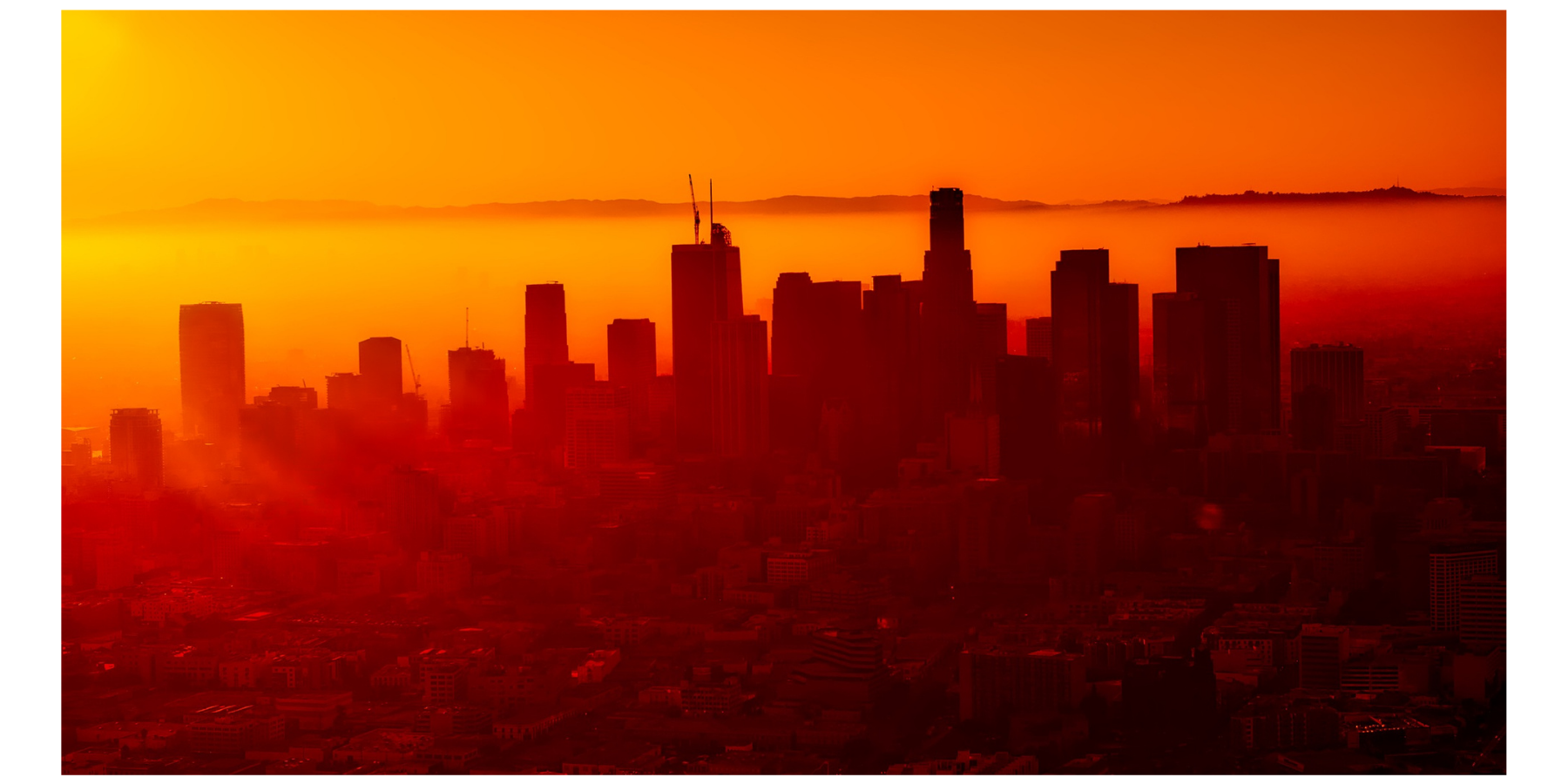 Overlook of bright orange-lit city.