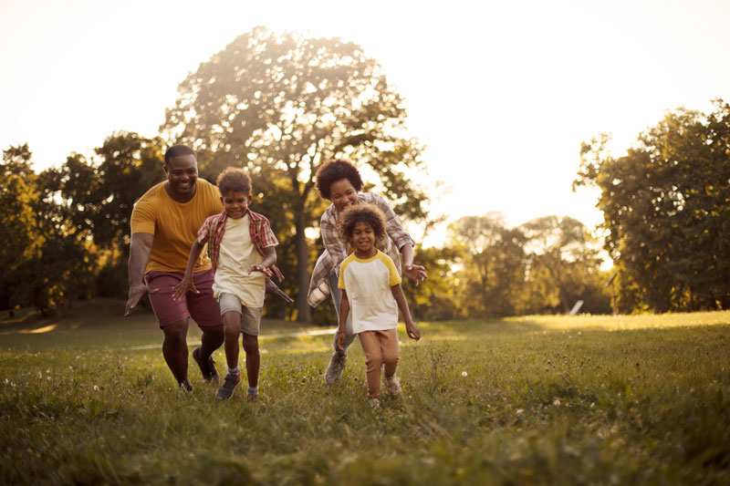 a family enjoying time at a park that received plant care services