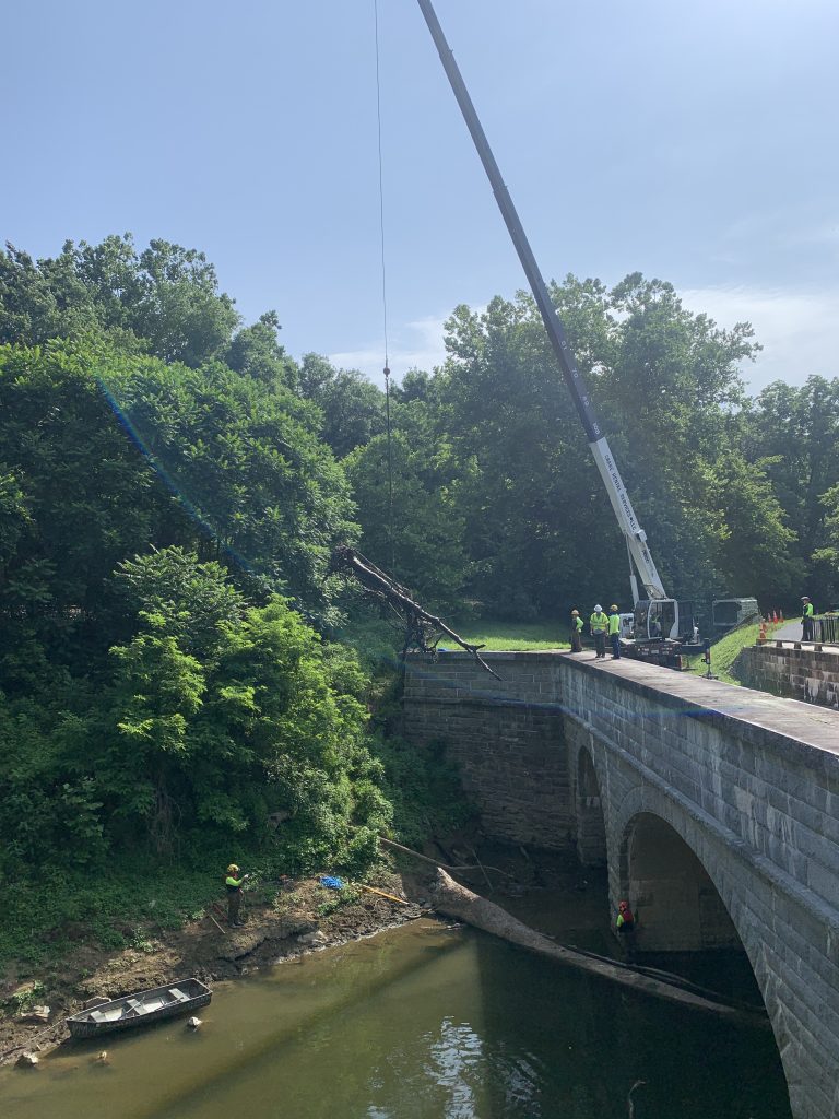 Crane removing logs from the aqueduct.